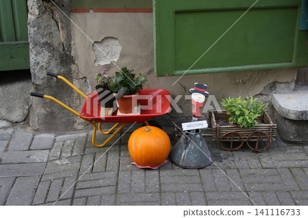 Charming Autumn Sidewalk Display Featuring a Red Wheelbarrow Pumpkin and Snowman Welcome Sign Charming Autumn Sidewalk Display Featuring a Red Wheelbarrow Pumpkin and Snowman Welcome Sign 141116733