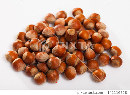 Pile of filberts on white surface Pile of filberts on white surface 141116828