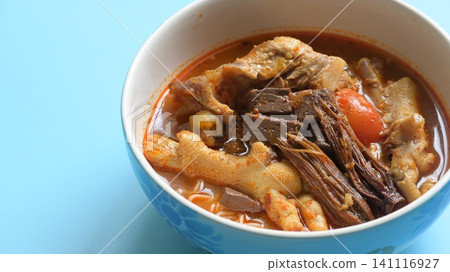 rice vermicelli with northern thai curry sauce on blue background rice vermicelli with northern thai curry sauce on blue background 141116927