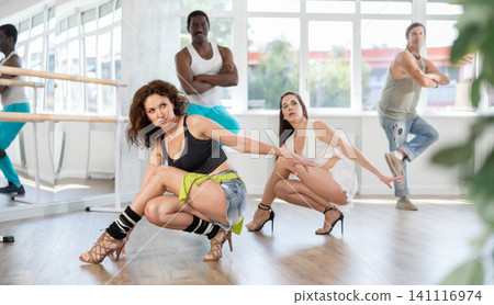 Fit and graceful woman partaking in high heels dance class 141116974