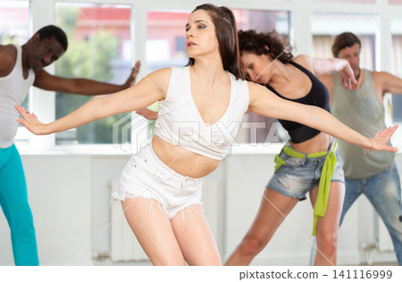 Girl in heels conducts lessons and teaches strip plasticity to visitors of dance Girl in heels conducts lessons and teaches strip plasticity to visitors of dance 141116999