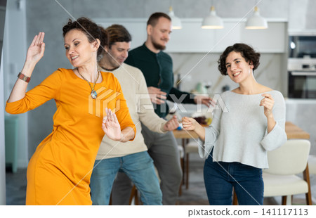 Men and women doing couple dancing during house party. 141117113