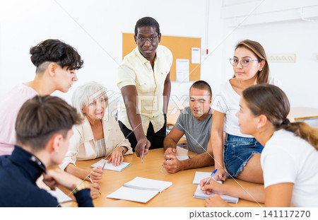 Multiracial mixed age group participating adult education class with African American tutor 141117270