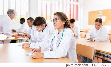 Young latin american woman listening to lecture during medical training Young latin american woman listening to lecture during medical training 141117272