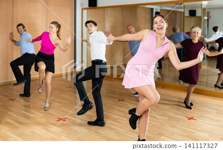 Young girl practicing lindy hop with partner in dance class Young girl practicing lindy hop with partner in dance class 141117327