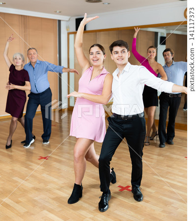 Young couple practicing passionate samba in dance class Young couple practicing passionate samba in dance class 141117373