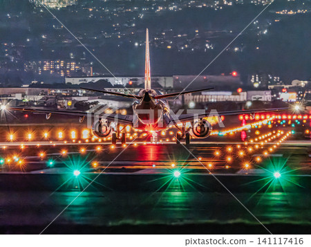 JAL aircraft taking off from Itami Airport at night JAL aircraft taking off from Itami Airport at night 141117416