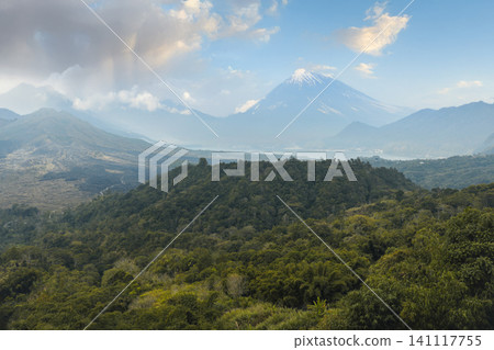Mount Agung rises over green hills in Kintamani, Bali Mount Agung rises over green hills in Kintamani, Bali 141117755