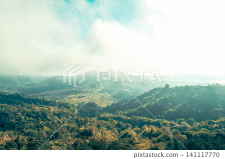 Mountains and greenery are visible under the cloudy sky Mountains and greenery are visible under the cloudy sky 141117770