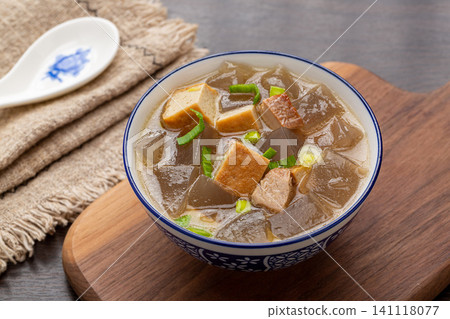 traditional Chinese sweet potato starch jelly soup with tofu cubes and green onions in a ceramic bowl traditional Chinese sweet potato starch jelly soup with tofu cubes and green onions in a ceramic bowl 141118077