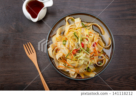 chinese cold starch noodles salad served with side dipping sauces of garlic and chili oil chinese cold starch noodles salad served with side dipping sauces of garlic and chili oil 141118212