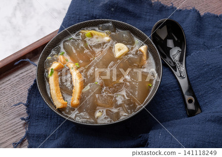 traditional Chinese sweet potato starch jelly soup with tofu cubes and green onions in a ceramic bowl traditional Chinese sweet potato starch jelly soup with tofu cubes and green onions in a ceramic bowl 141118249