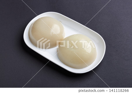 slices of raw buckwheat starch jelly blocks served on a black triangular plate 141118266