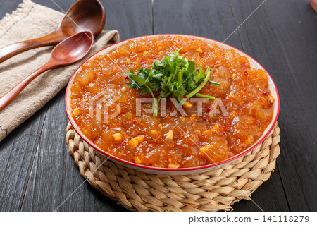 stir-fried sweet potato starch jelly with spicy chili sauce and fresh coriander in a bowl, top view stir-fried sweet potato starch jelly with spicy chili sauce and fresh coriander in a bowl, top view 141118279