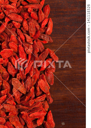 Dried Goji berries on wooden surface Dried Goji berries on wooden surface 141118326