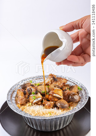 Chinese claypot rice with pork ribs in douchi black bean sauce and straw mushrooms in foil bowl Chinese claypot rice with pork ribs in douchi black bean sauce and straw mushrooms in foil bowl 141118486