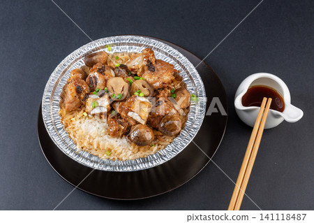 Chinese claypot rice with pork ribs in douchi black bean sauce and straw mushrooms in foil bowl Chinese claypot rice with pork ribs in douchi black bean sauce and straw mushrooms in foil bowl 141118487