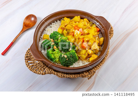 Chinese Curry Chicken Claypot Rice Casserole with Vegetables, Top View Chinese Curry Chicken Claypot Rice Casserole with Vegetables, Top View 141118495