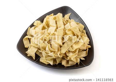 Traditional Tianjin guobacai ingredients, sliced crispy mung bean crepe ribbons on black plate Traditional Tianjin guobacai ingredients, sliced crispy mung bean crepe ribbons on black plate 141118563