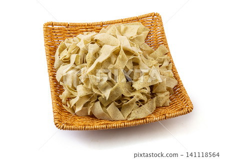 Traditional Tianjin guobacai ingredients, sliced crispy mung bean crepe ribbons on black plate Traditional Tianjin guobacai ingredients, sliced crispy mung bean crepe ribbons on black plate 141118564
