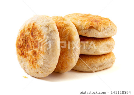 A stack of traditional Chinese crispy crusted shaobing flatbread buns, isolated A stack of traditional Chinese crispy crusted shaobing flatbread buns, isolated 141118594