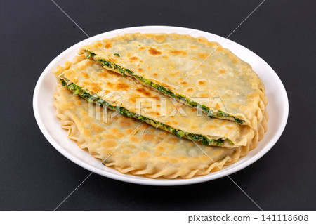 traditional Chinese Chive and Egg Stuffed Flatbread on Plate, Savory Homemade Street Food traditional Chinese Chive and Egg Stuffed Flatbread on Plate, Savory Homemade Street Food 141118608