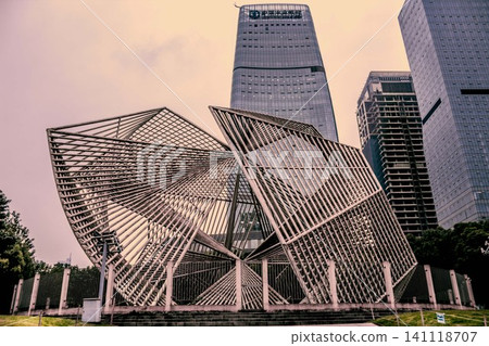 Modern metal sculpture in front of skyscrapers in Chongqing, China Modern metal sculpture in front of skyscrapers in Chongqing, China 141118707