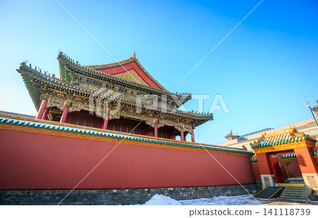 Traditional red wall and ornate roof of the Forbidden City in Beijing, China under a clear blue sky Traditional red wall and ornate roof of the Forbidden City in Beijing, China under a clear blue sky 141118739