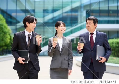 Business people walking and chatting during their break. Business people walking and chatting during their break. 141118871