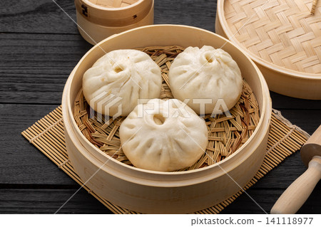 Chinese Mini Steamed Buns in Bamboo Steamer Traditional Dim Sum Chinese Mini Steamed Buns in Bamboo Steamer Traditional Dim Sum 141118977