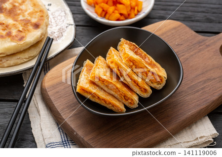 chinese crispy pan fried chicken meat pies cut in half on rustic wooden tray, sweet spicy flavor 141119006