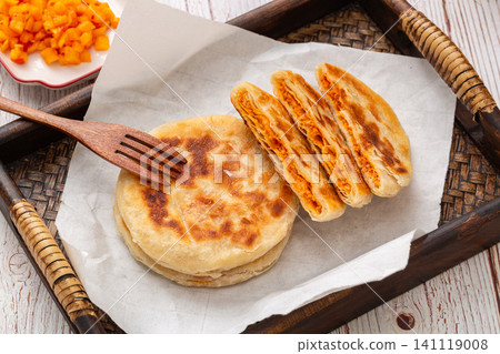 chinese crispy pan fried chicken meat pies cut in half on rustic wooden tray, sweet spicy flavor chinese crispy pan fried chicken meat pies cut in half on rustic wooden tray, sweet spicy flavor 141119008