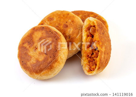 a stack of Chinese pan fried New Orleans chicken meat pies showing savory filling, isolated a stack of Chinese pan fried New Orleans chicken meat pies showing savory filling, isolated 141119016
