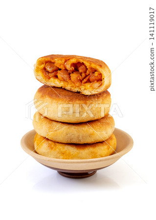 a stack of Chinese pan fried New Orleans chicken meat pies showing savory filling, isolated a stack of Chinese pan fried New Orleans chicken meat pies showing savory filling, isolated 141119017