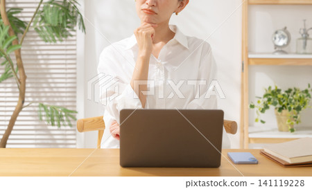 Middle-aged women struggling with computers Middle-aged women struggling with computers 141119228