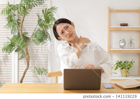 Middle-aged women struggling with computers Middle-aged women struggling with computers 141119229