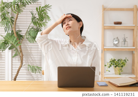 Middle-aged women struggling with computers Middle-aged women struggling with computers 141119231