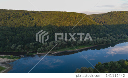 Dniester River flows through canyon landscape in Ukraine during sunset Dniester River flows through canyon landscape in Ukraine during sunset 141119442