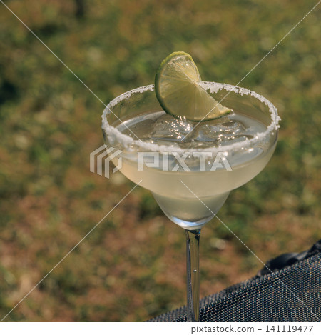 Refreshing margarita drink with lime served in a garden setting during summer Refreshing margarita drink with lime served in a garden setting during summer 141119477
