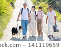 A two-generation family enjoying a walk with their beloved dog. 141119659