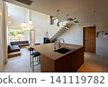 Interior view of the living room with a high ceiling and island kitchen 141119782