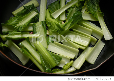 Stir-fried komatsuna greens being cooked Stir-fried komatsuna greens being cooked 141120793