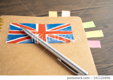 UK flag with pen on english language book. UK flag with pen on english language book. 141120906