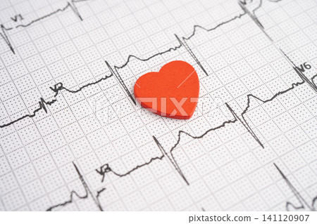 Red heart on electrocardiogram ECG with red heart, heart wave, heart attack, cardiogram report. Red heart on electrocardiogram ECG with red heart, heart wave, heart attack, cardiogram report. 141120907
