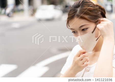 A young woman wearing a mask A young woman wearing a mask 141121036