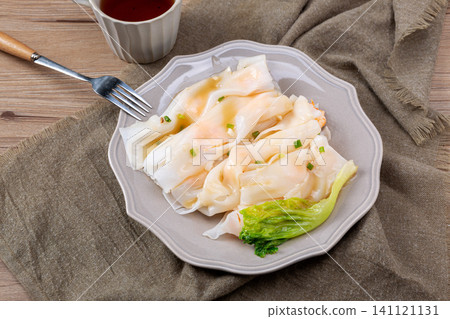 Cantonese dim sum steamed rice noodle rolls with shrimp and fresh lettuce 141121131