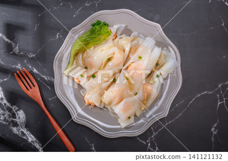 Cantonese dim sum steamed rice noodle rolls with shrimp and fresh lettuce Cantonese dim sum steamed rice noodle rolls with shrimp and fresh lettuce 141121132