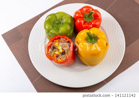 homemade stuffed bell peppers with rice and minced meat served on a plate. homemade stuffed bell peppers with rice and minced meat served on a plate. 141121142