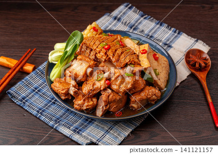 chinese traditional style braised pork ribs cooked with tofu, sweet corn and greens in a savory sauce. chinese traditional style braised pork ribs cooked with tofu, sweet corn and greens in a savory sauce. 141121157