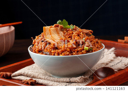 traditional Chinese flavored rice topped with tender braised pork belly slices in a blue-rimmed ceramic bowl. traditional Chinese flavored rice topped with tender braised pork belly slices in a blue-rimmed ceramic bowl. 141121163